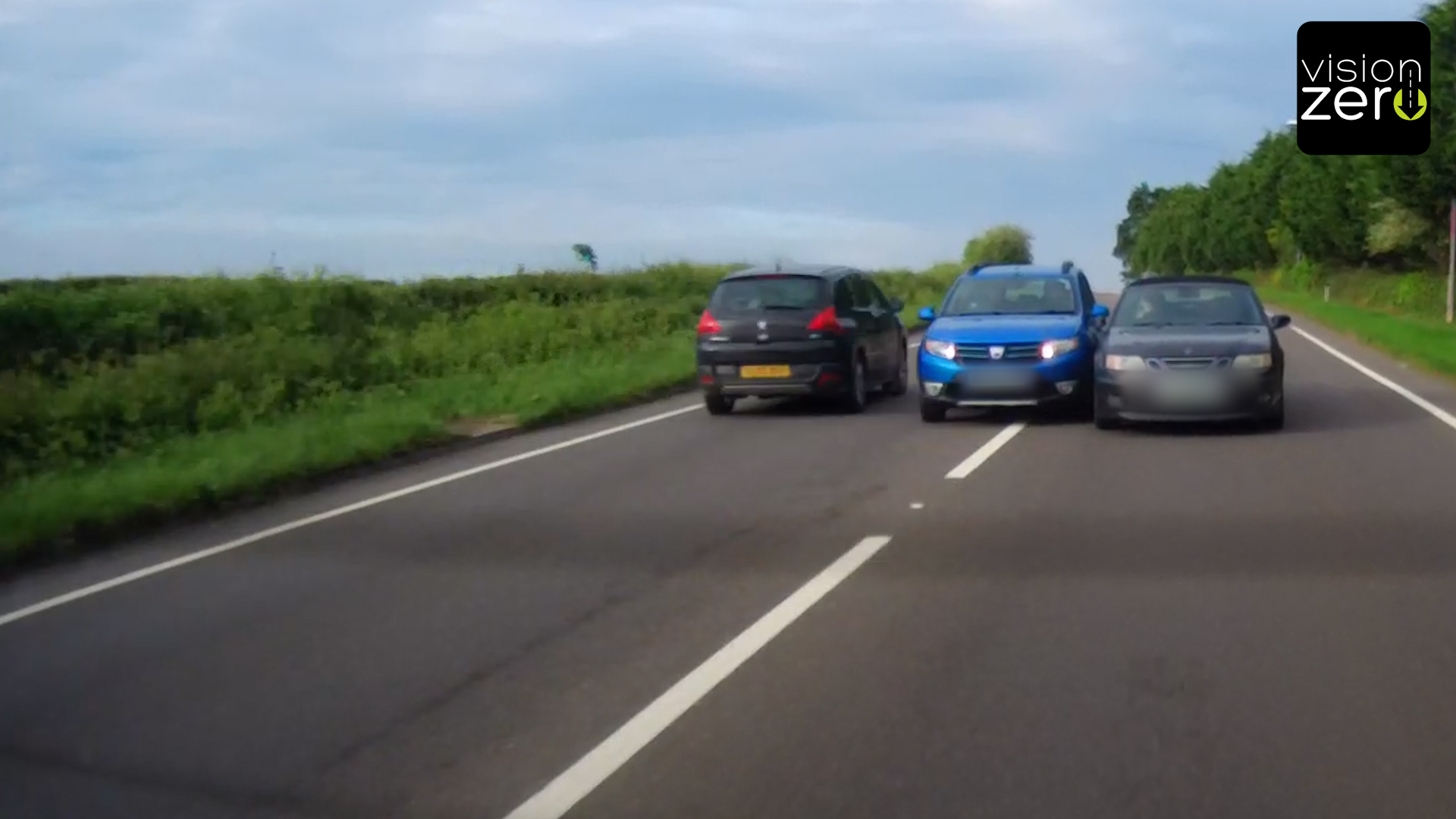 Two lanes, three cars in a row. Middle car squeezing between other two cars