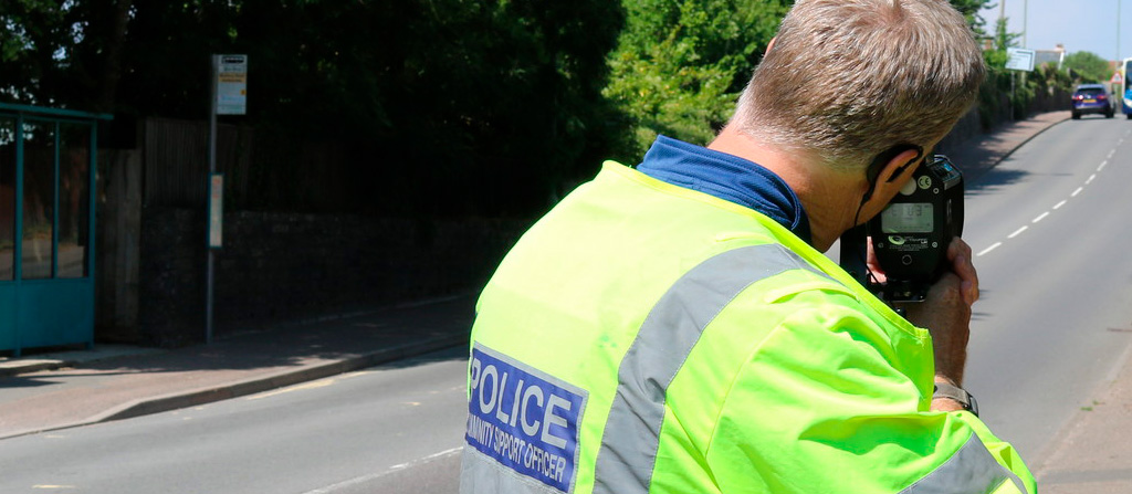 PCSO in his area checking speed of on-coming vehicles on a busy residential road