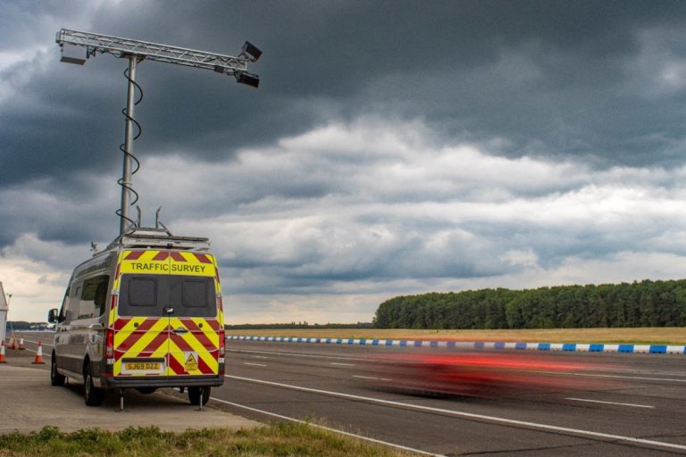Speed cameras on top of a van by the side of a road